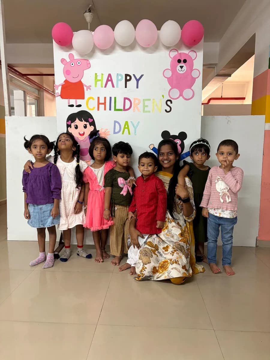 Children dressed in festive celebration crowns smiling during Children's Day party