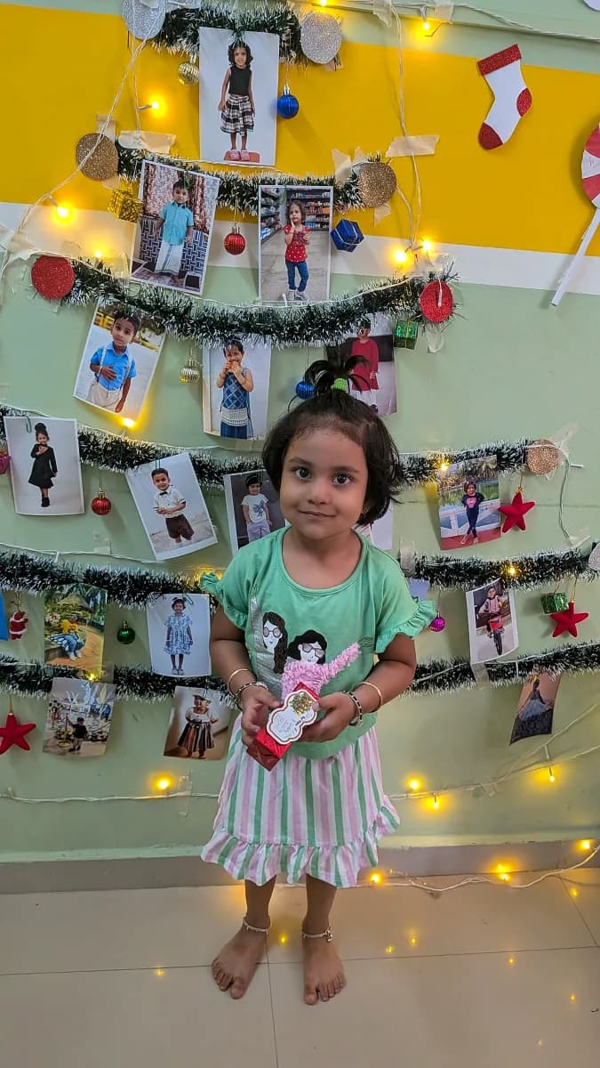Children wearing Santa Claus hats celebrating Christmas around classroom tree