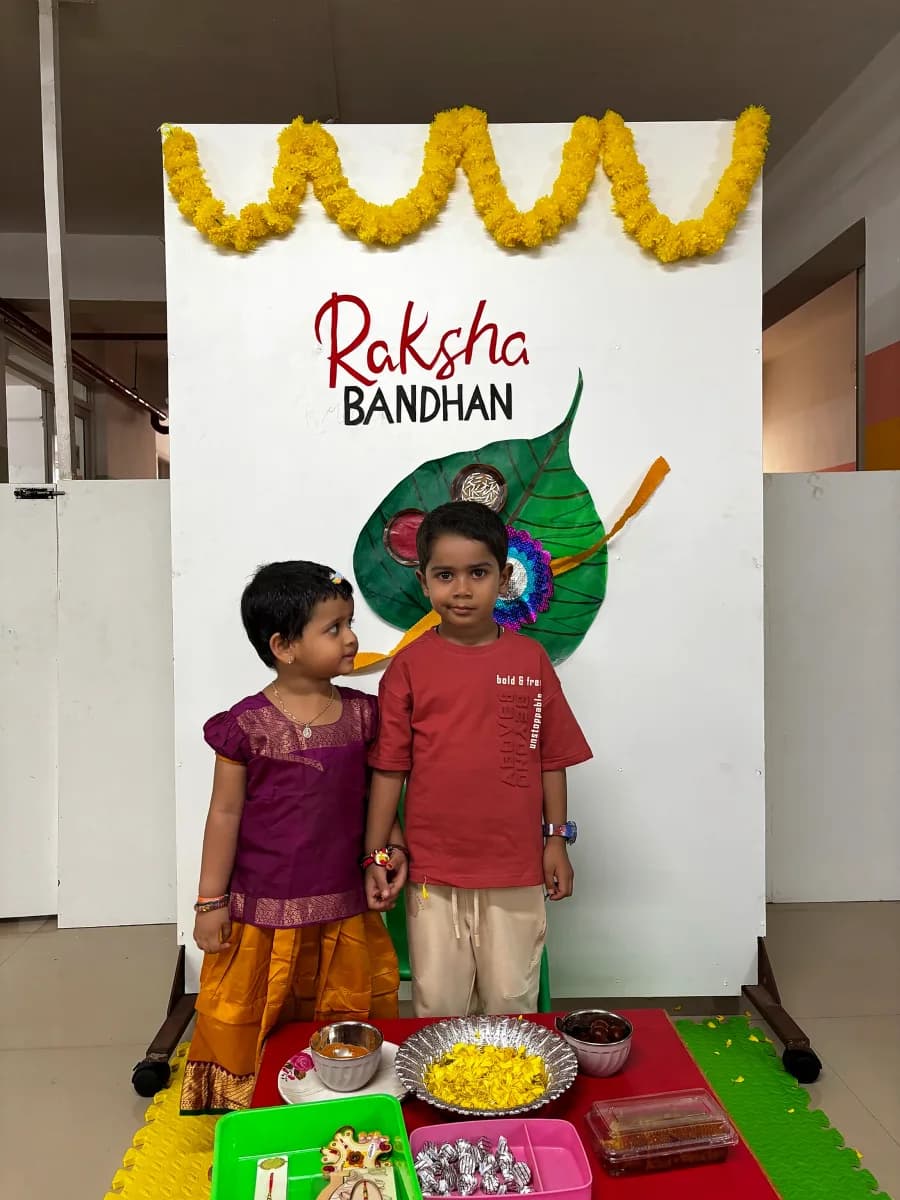 Young students showcasing colorful rakhis tied on their wrists during festival celebration