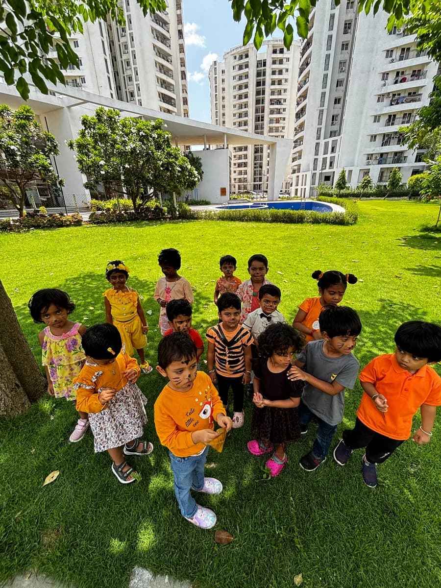 Children roaring playfully in handmade tiger ears and face paint on Tiger Day