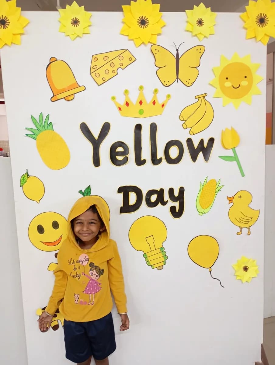 Children wearing bright yellow clothes holding handmade paper sunflowers