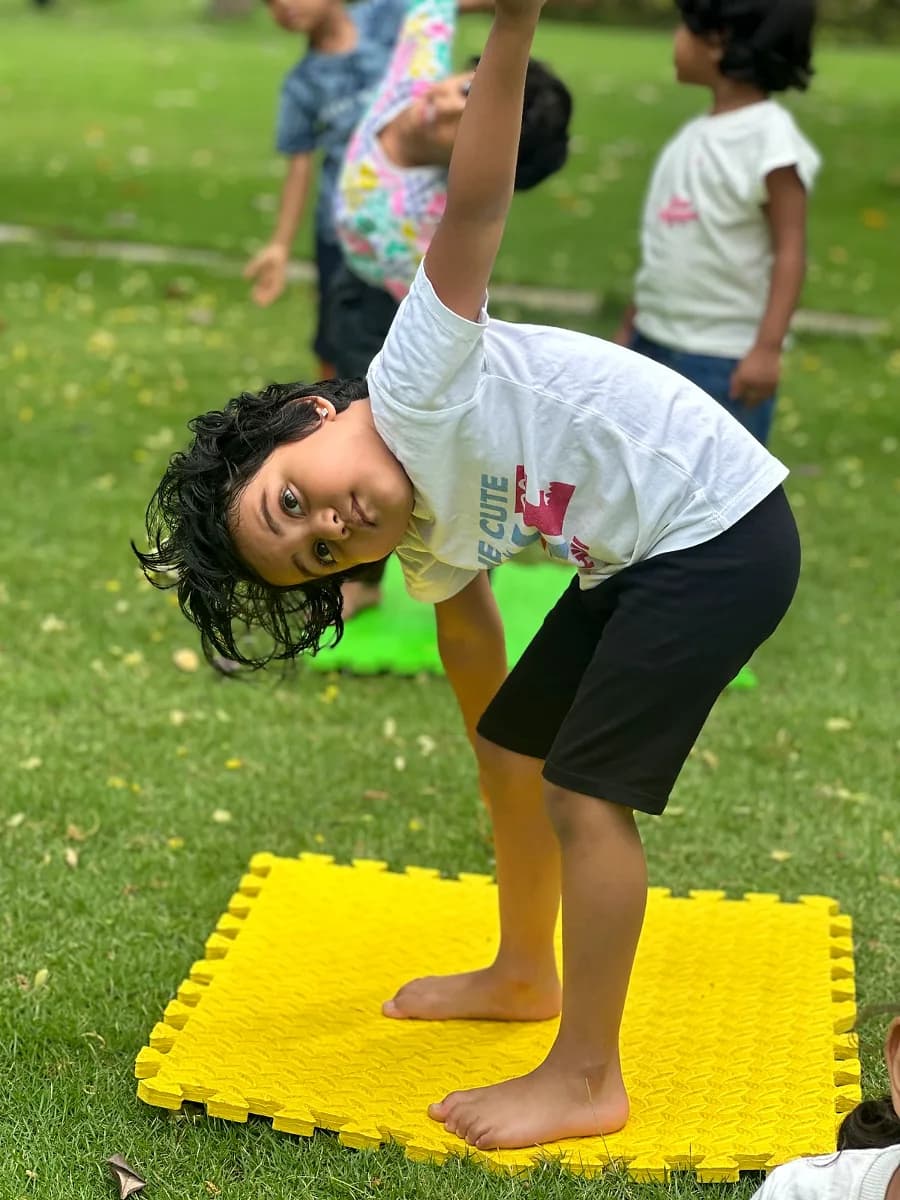 Young children seated in lotus pose during calm morning yoga session